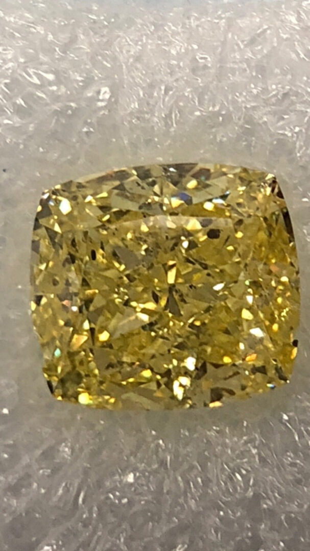 Large yellow cushion cut diamond.