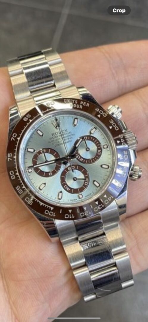 Silver Rolex Daytona chronograph watch on wrist.